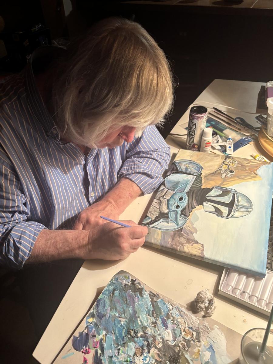 Tom Goetz hand-painting The Desert Is This Way in his South Florida studio