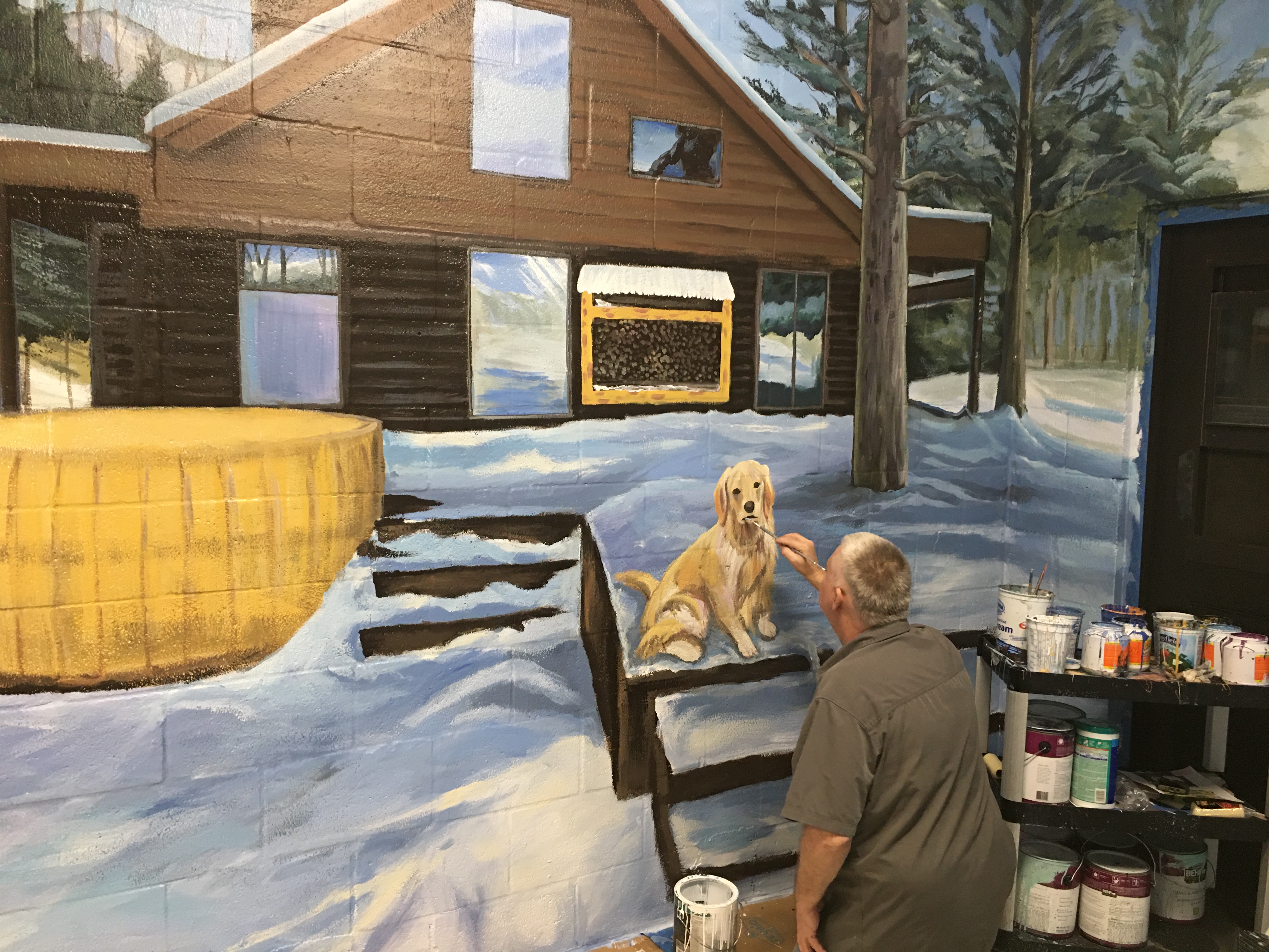 Tom painting winter cabin mural at Big Dog Ranch — WIP